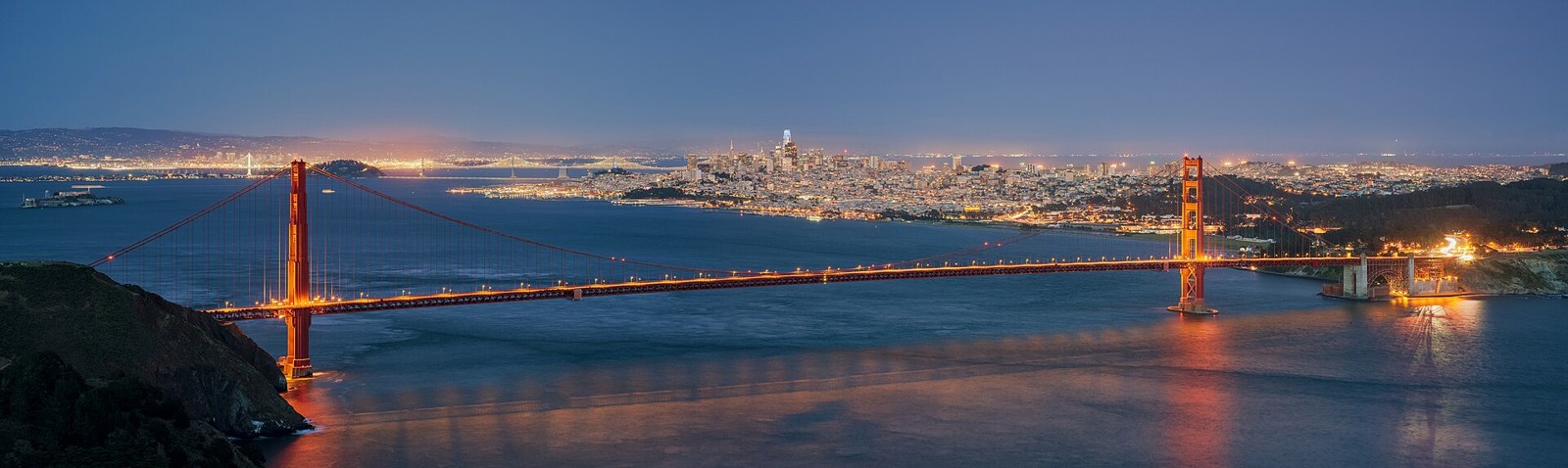 Golden Gate Bridge and San Francisco skyline across the bay at blue hour
